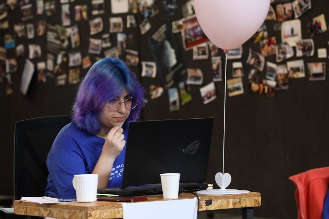 Event coordinator planning a team building day on a laptop